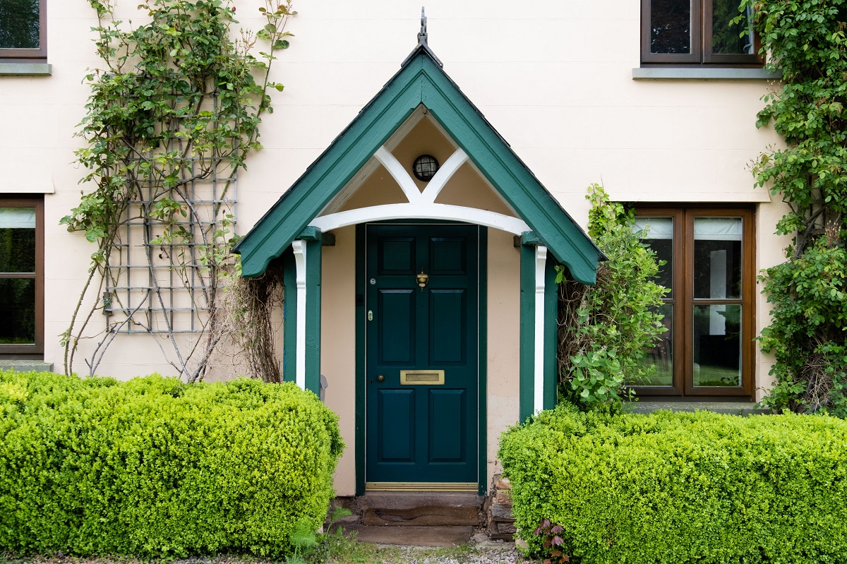 English-style home with a green front door